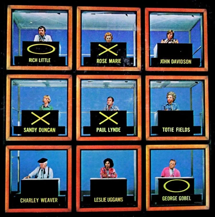 Screenshot from the gameshow Hollywood Squares from the 1960s. Celebrities fo the time are each seated in a single box arranged vertically into a 3x3 grid.