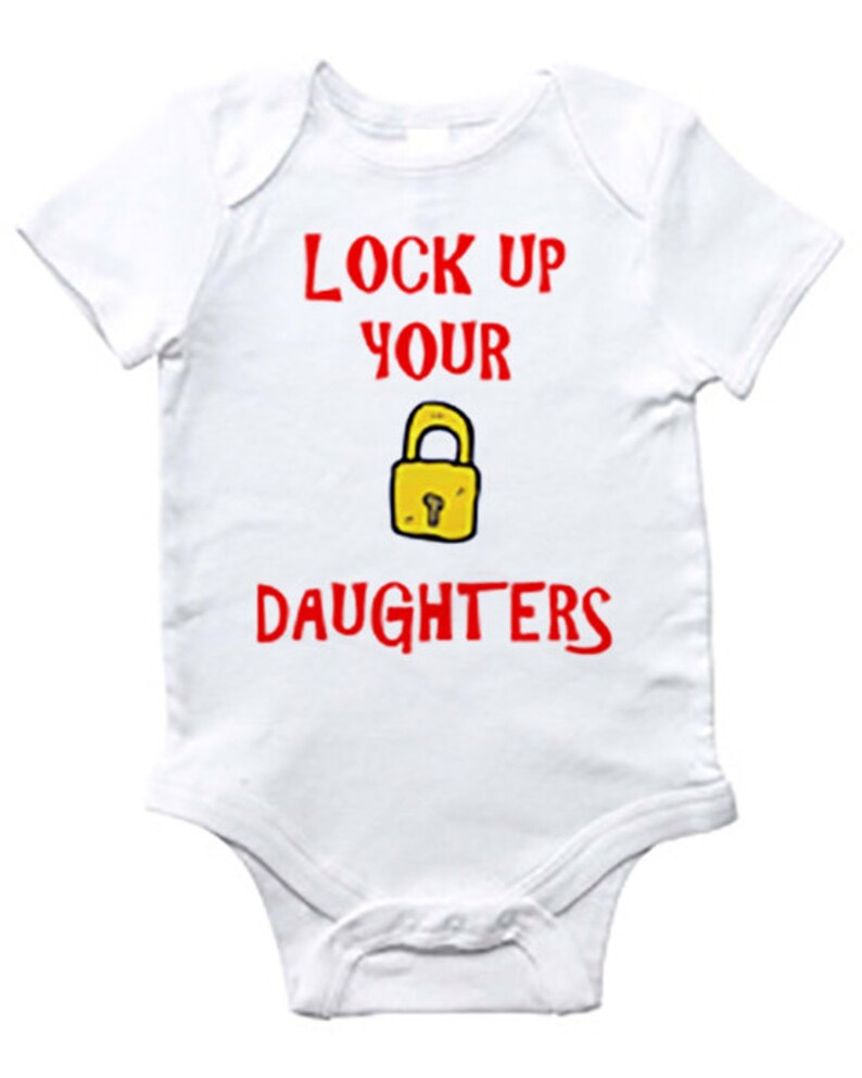 A baby's onesie with the text 'Lock up your daughters' written on it along with a drawing of a padlock.