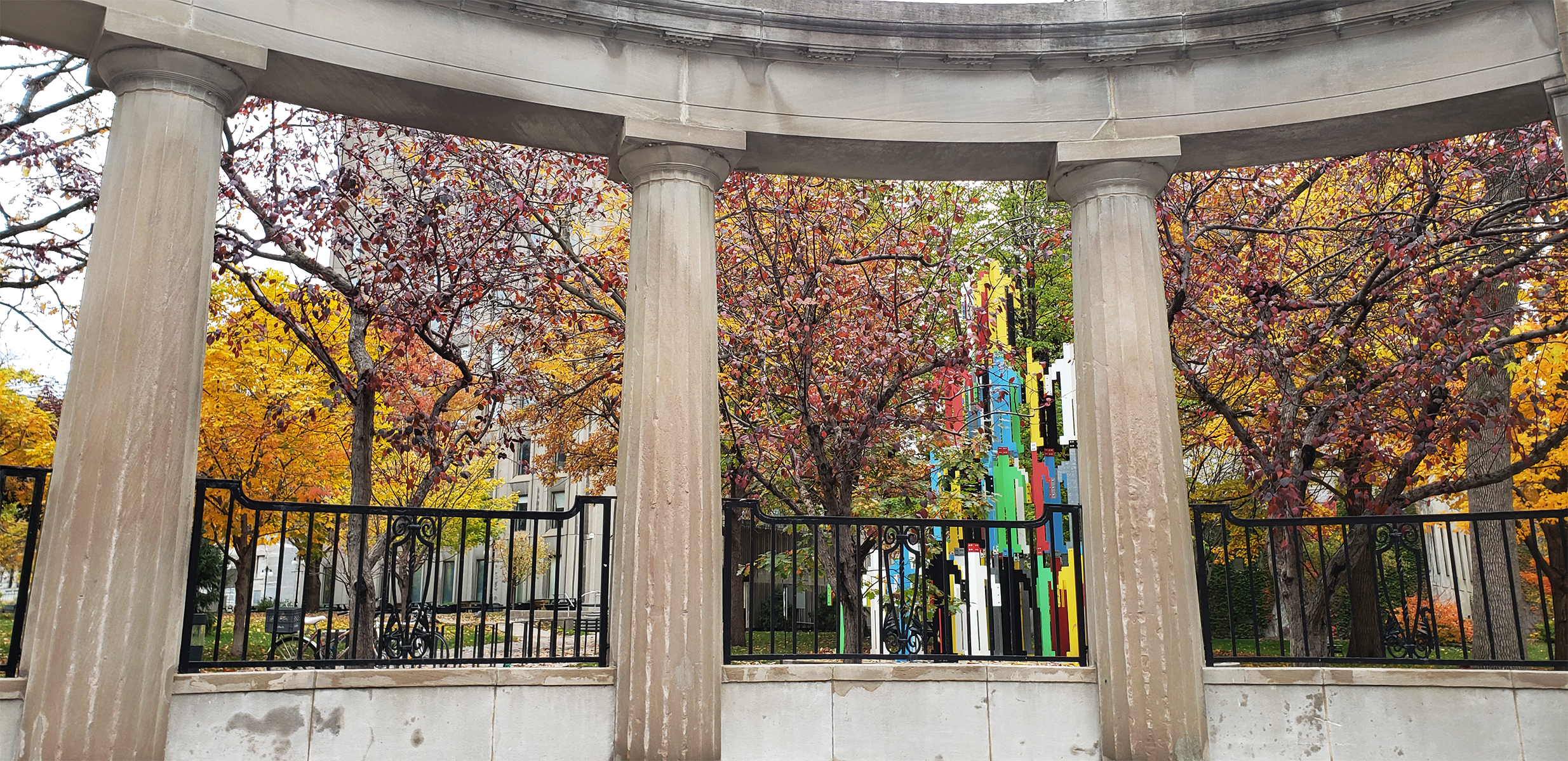 Stone columns with metal fences between them.